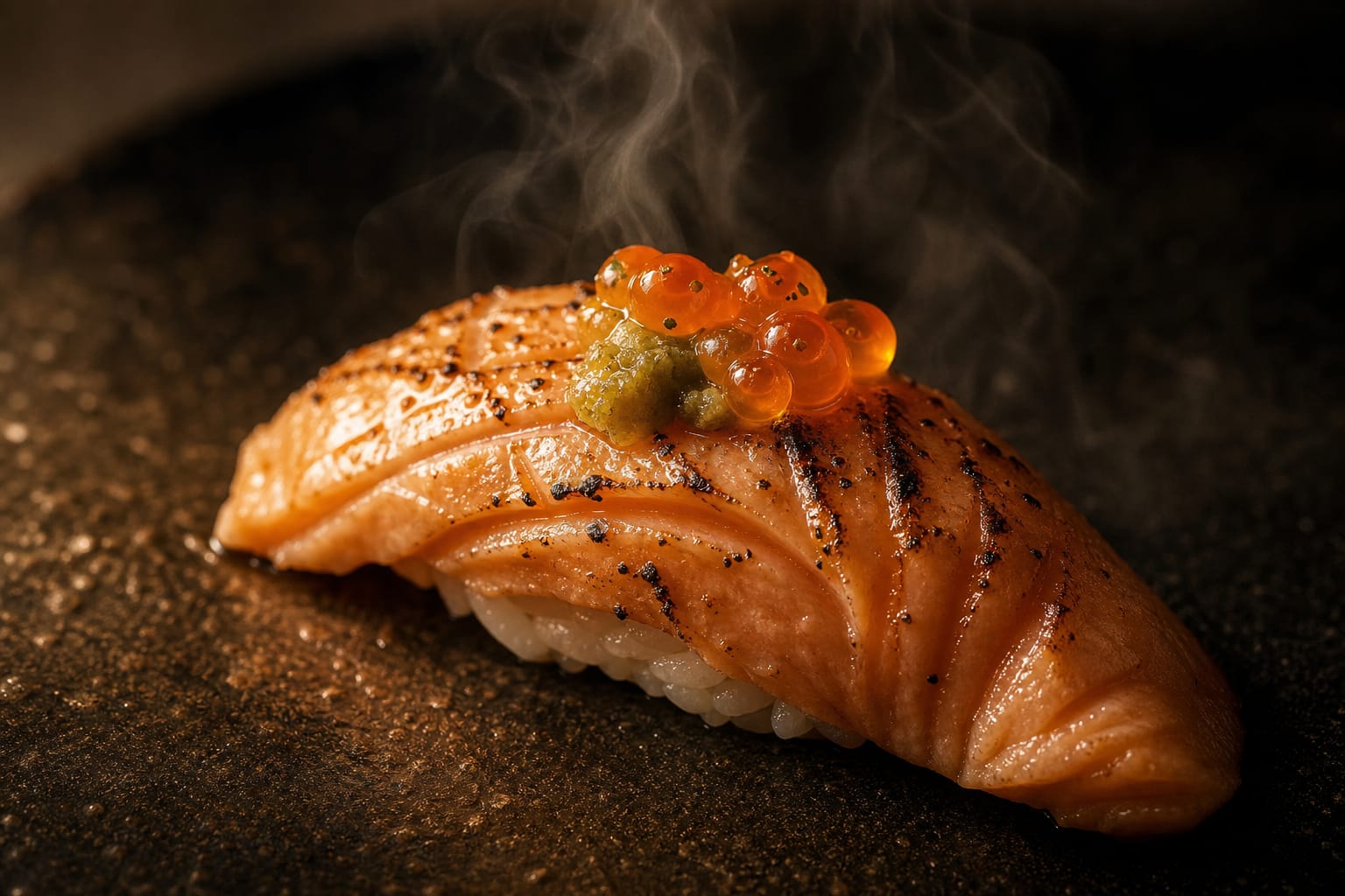 Torched salmon belly nigiri with char marks, yuzu kosho and ikura roe